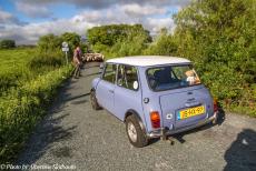 Ireland 2017 - Classic Car Road Trip Ireland: A shepherd with a herd of sheep walking in front of the Mini Authi on the road near Westport, a small town in...