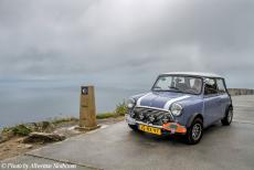 Portugal - Classic Car Road Trip: Our own classic Mini next to the zero kilometre signpost of the Route of Santiago de Compostela at Cape...