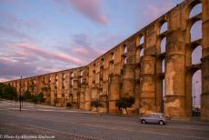 Portugal, IMM Praia de Mira - Classic Car Road Trip Portugal:&nbsp;Our Classic Mini Authi looks even smaller beside the imposing Amoreira Aqueduct in Elvas. This massive...