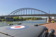 75 years after the Battle of Arnhem - Classic Car Road Trip: Race to the Bridge 2019, a Ford GPW RAF Jeep driving on the quay road towards the Rhine Bridge in Arnhem. In 1978, the...