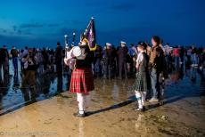 Normandy 2014 - Classic Car Road Trip Normandy: A Scottish bagpiper on Juno Beach in front of the Canada House in Bernières-sur-Mer during the...