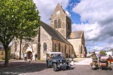Normandy, 70 years after D-Day - Memorial road trip through Normandy: Our own RAF-blue WWII Jeep in front of the church of Sainte-Mère-Église with an effigy of... Normandy, 70 years after D-Day - Memorial road trip through Normandy: Our own RAF-blue WWII Jeep in front of the church of Sainte-Mère-Église with an effigy of...